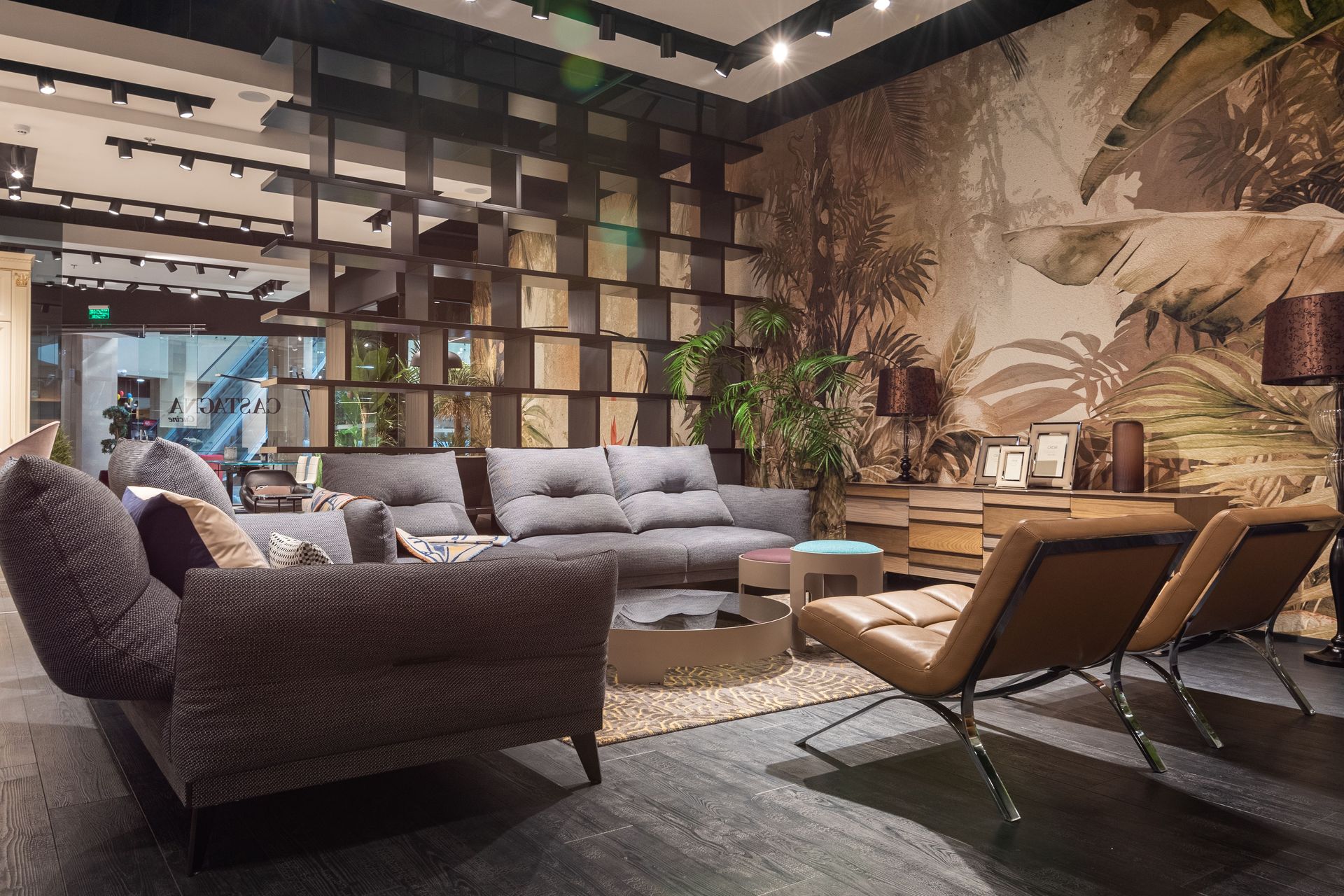 Comfortable gray sofas leather chairs and creative coffee tables in spacious trendy living room